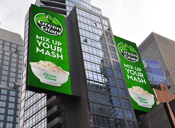 Large screen displaying an ad in downtown square